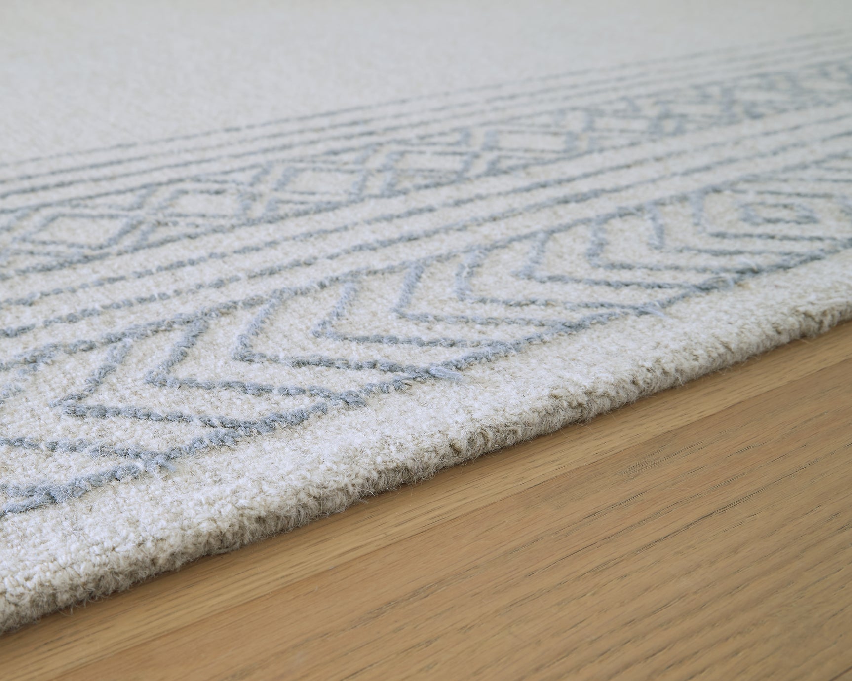 Rolled view of Azelhurst wool area rug edge detail