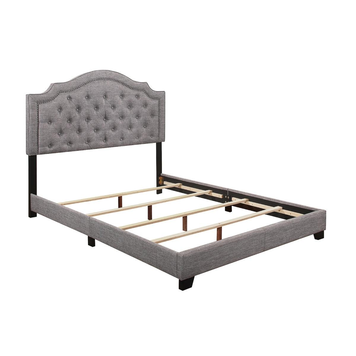 Close-up of tufted grey fabric headboard on king bed