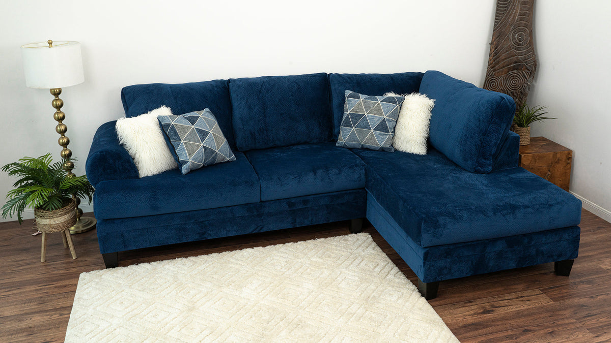 Room view of Selena Navy 124" Sectional sofa with pillows