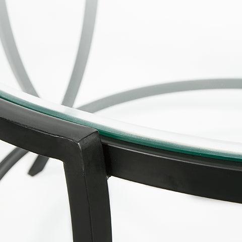 Close-up of glass tabletop and black metal finish on Tarrin Table