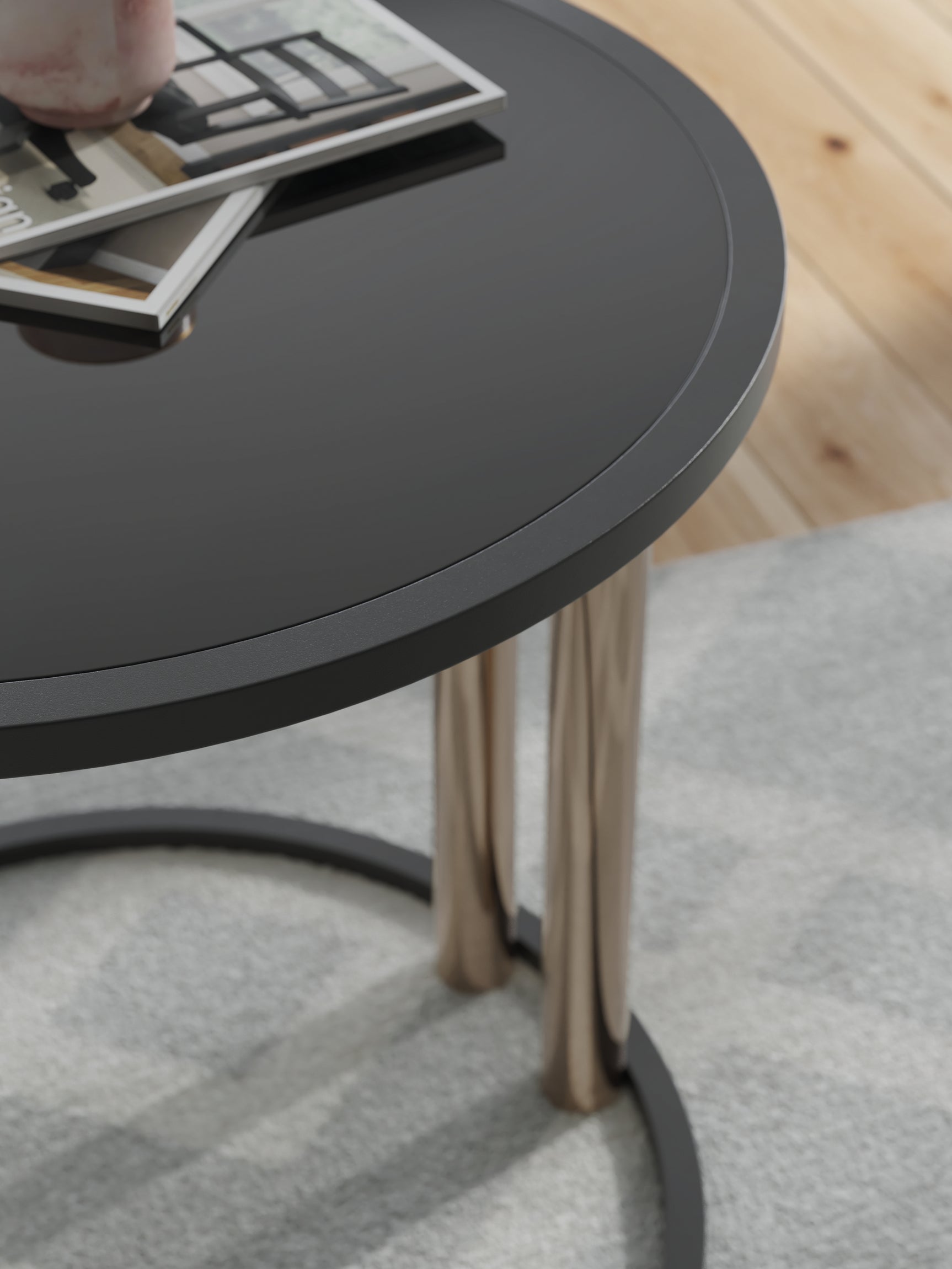 Detail of Hannerly end table with black glass top and metal legs
