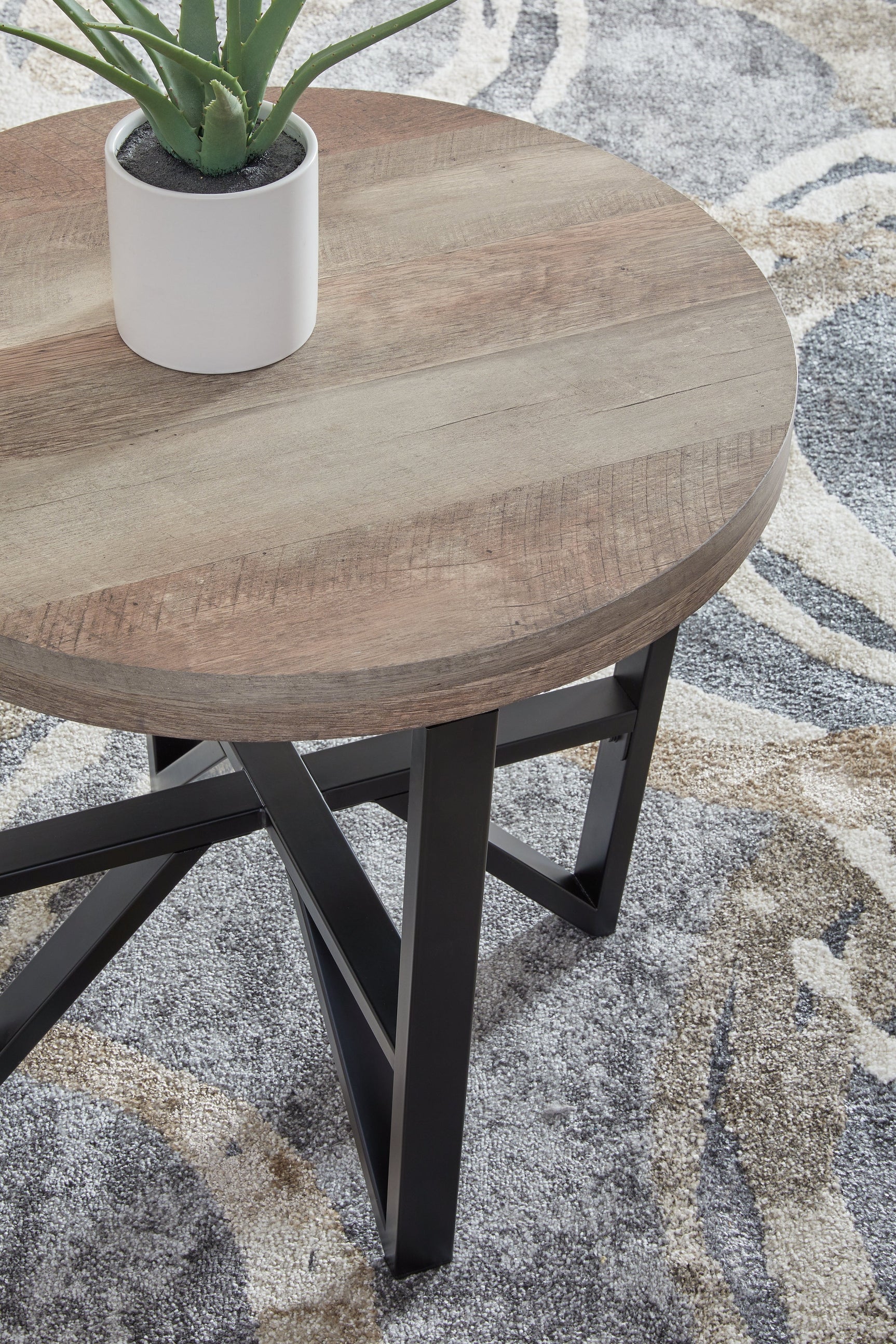 Close detail of end table base with matte black powdercoat finish
