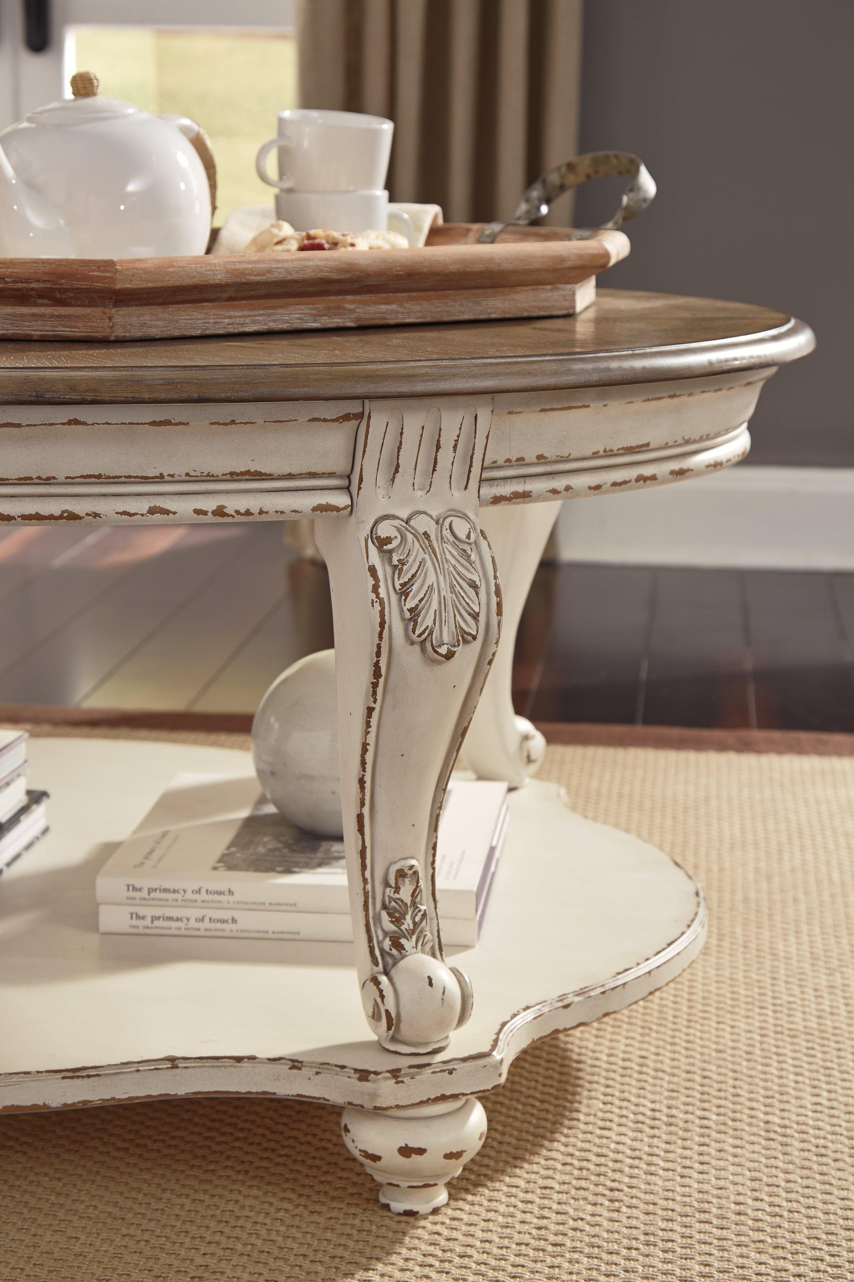 Realyn Oval White Brown Coffee Table decorative corbel detail