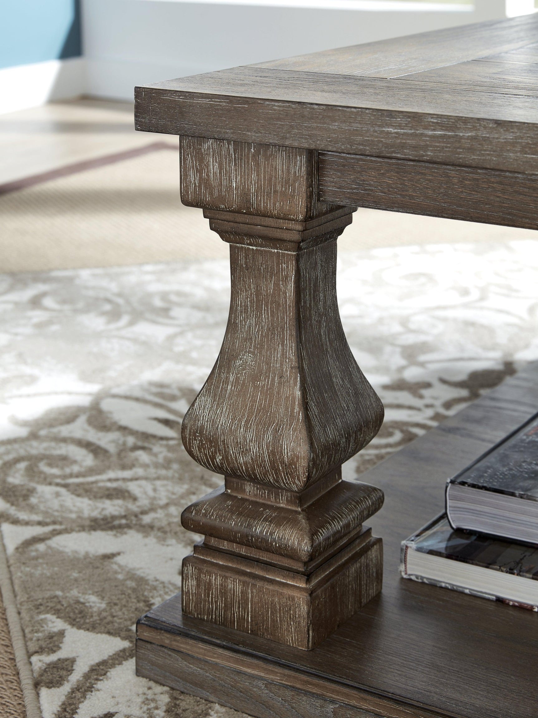 Johnelle Gray rectangular coffee table with weathered finish from front angle