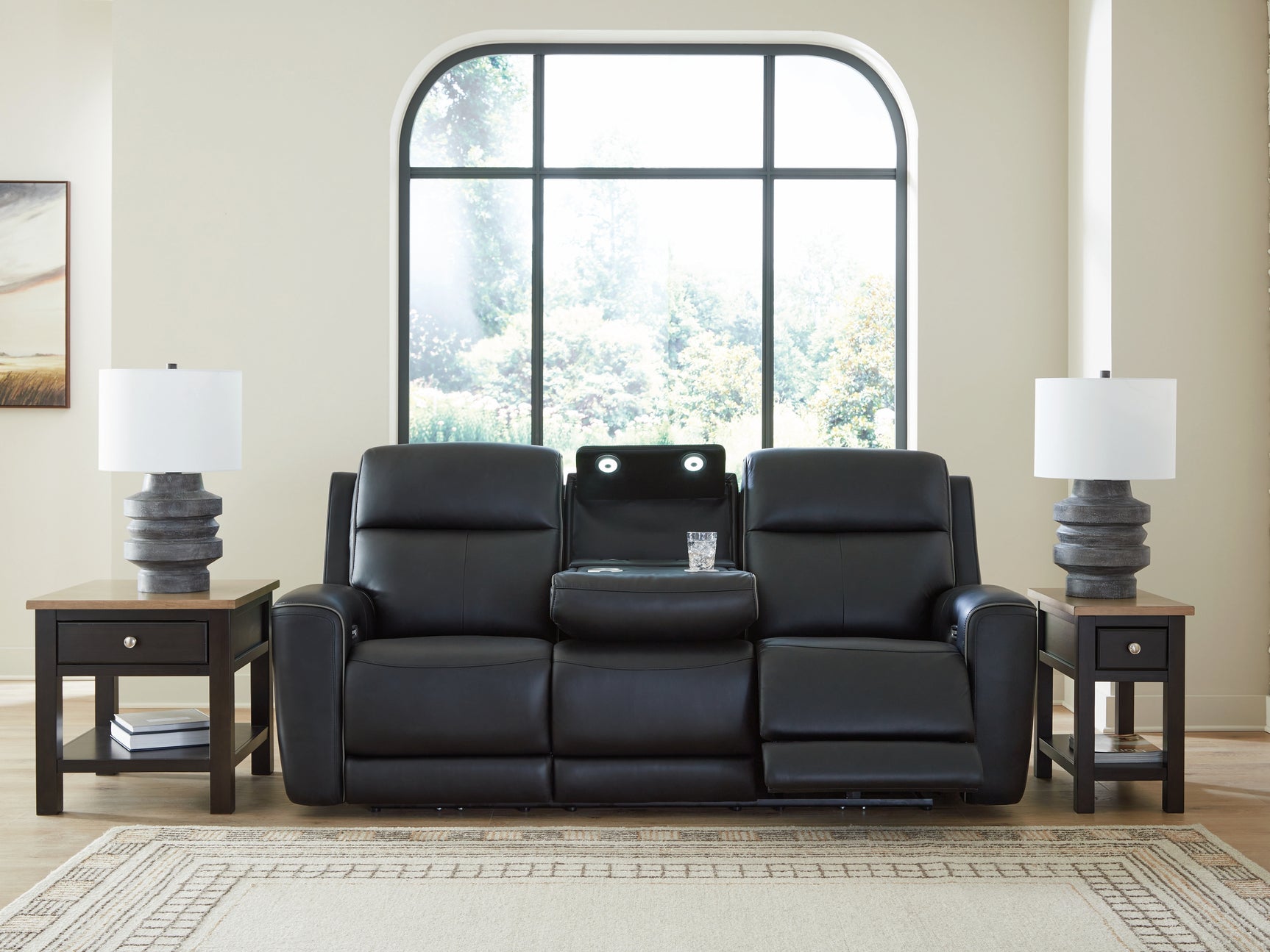 Drop-down table with LED lights and dual cup holders open on sofa