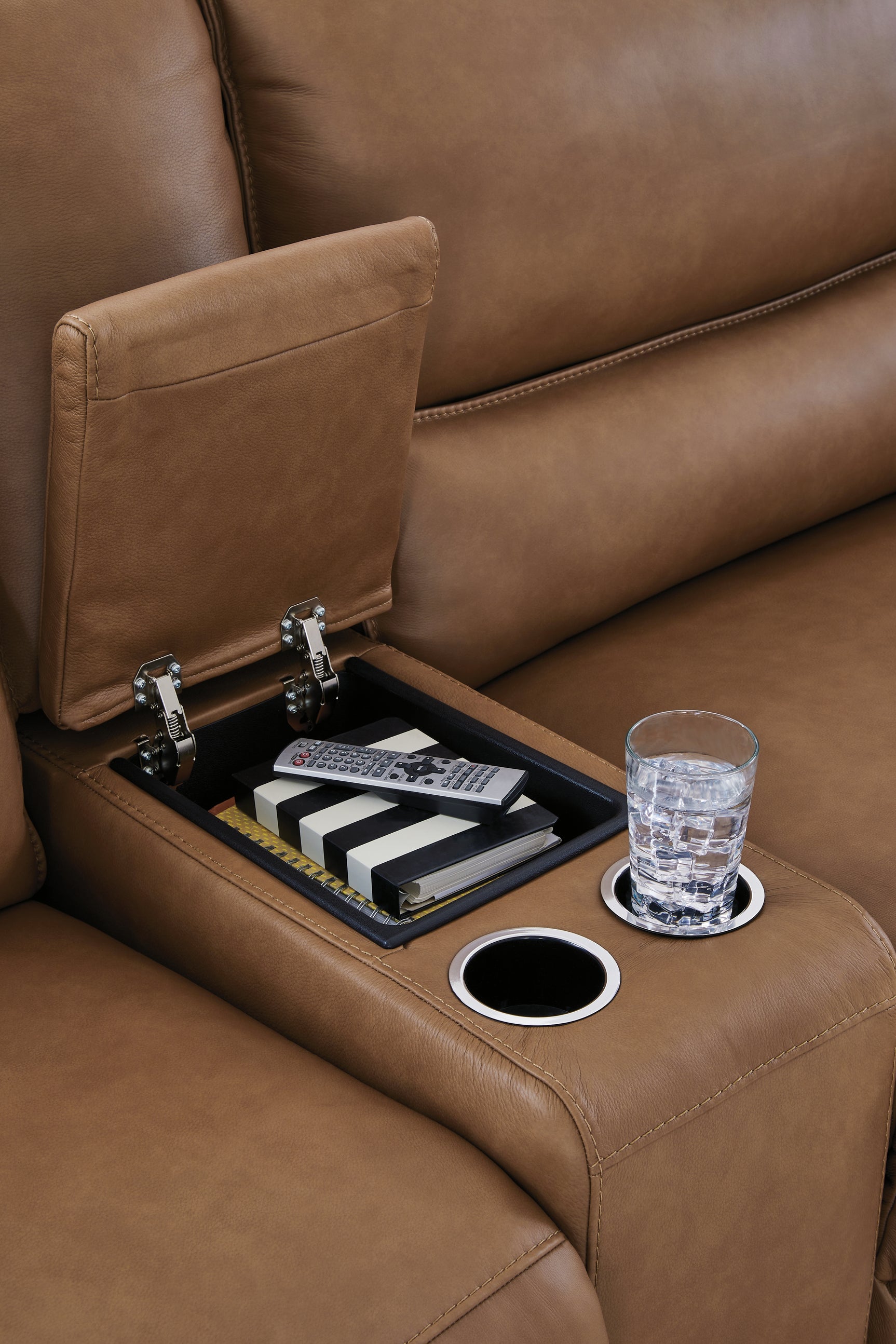 Storage console close-up with cup holders and hidden compartment