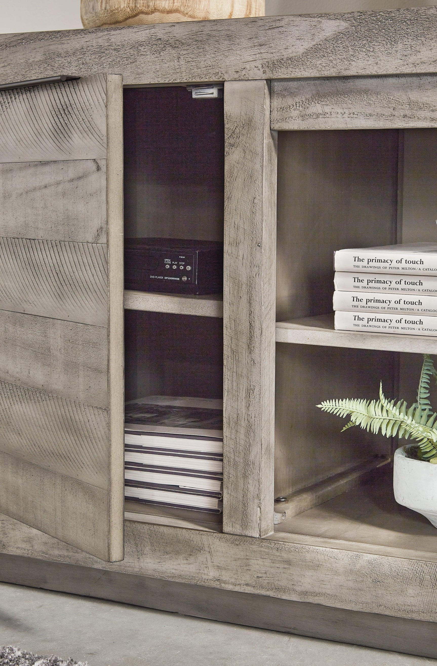 Close-up of Naydell Gray TV Stand weathered gray finish