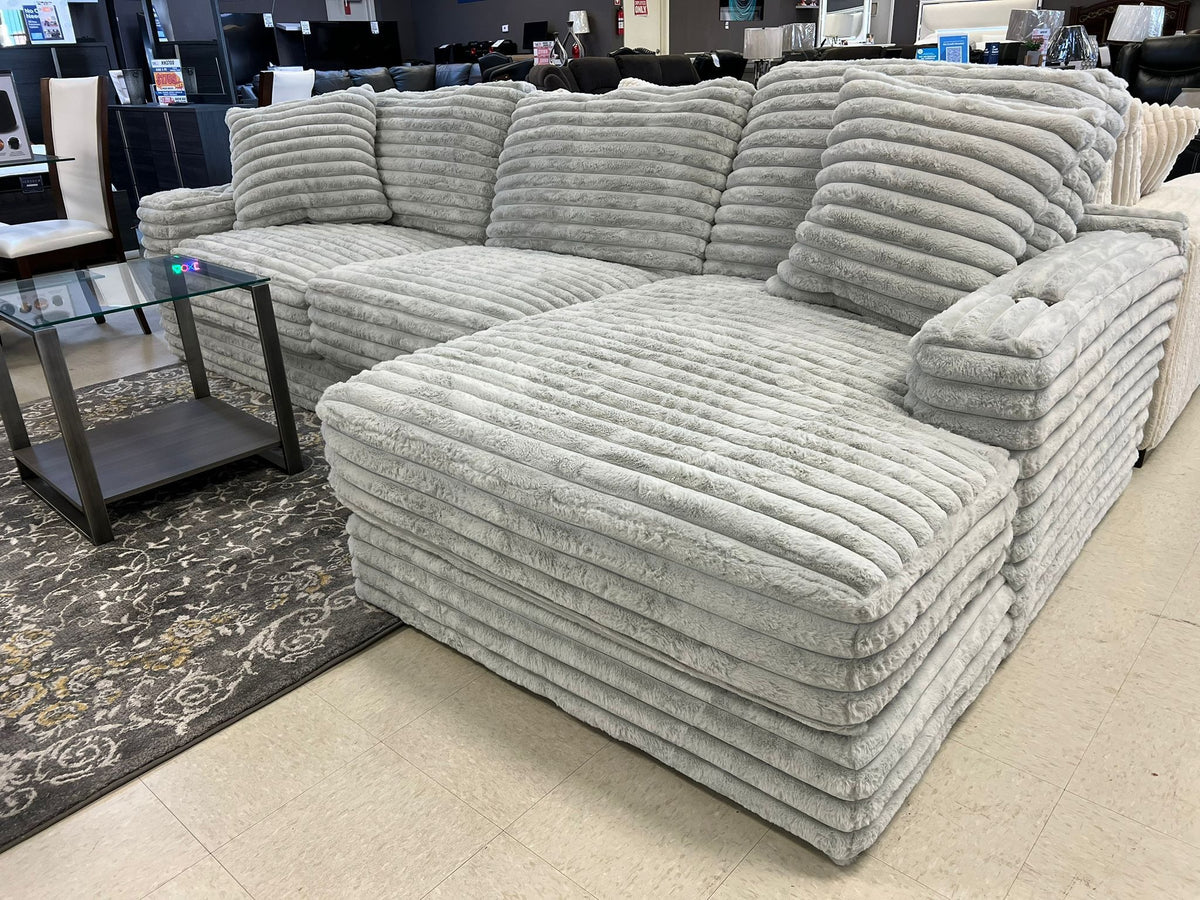 Side view of Kelly oversized gray corduroy sectional sofa with cupholders