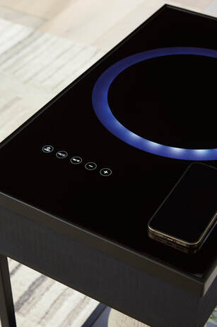 Top view of wireless speaker integration in glass tabletop