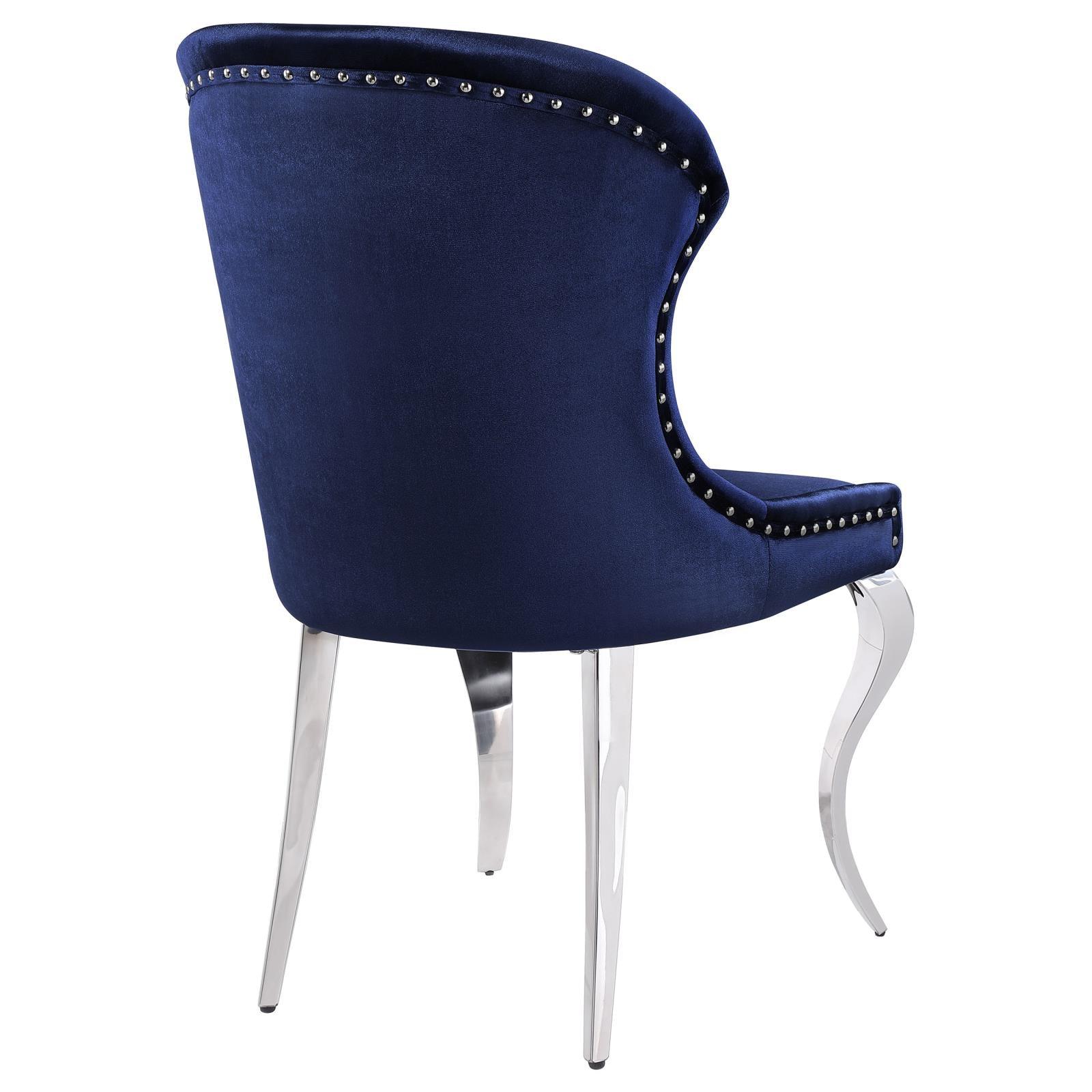 Nailhead trim along side edges of wingback dining chair