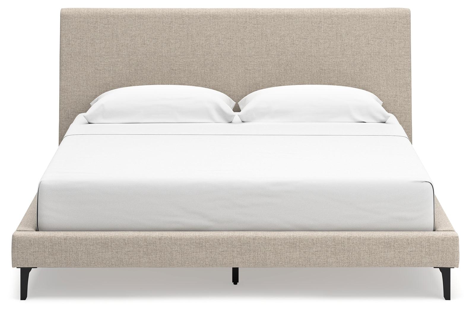 Low-profile footboard of Cielden King Upholstered Bed