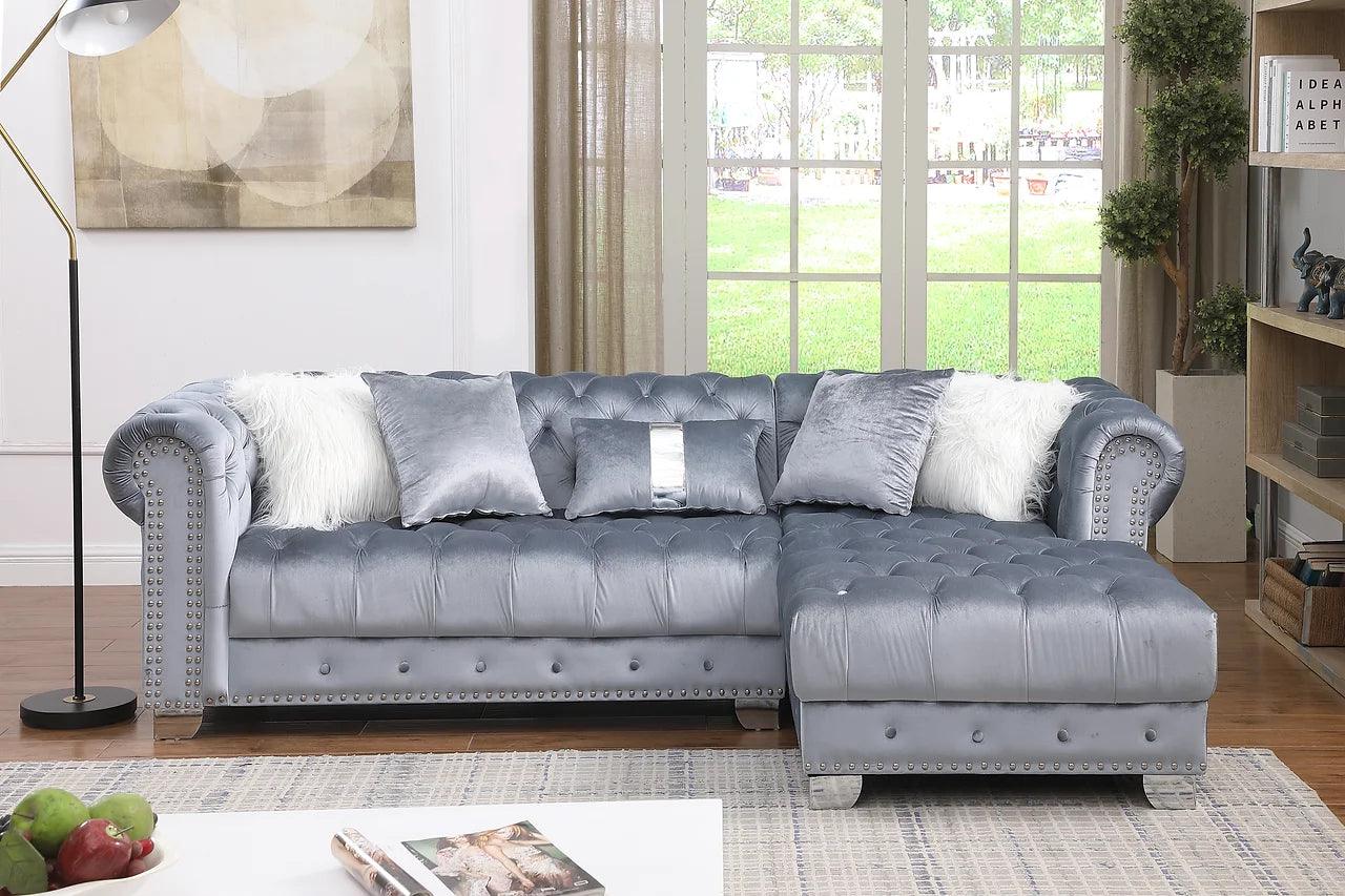 Close-up detail of grey velvet tufted upholstery on sectional