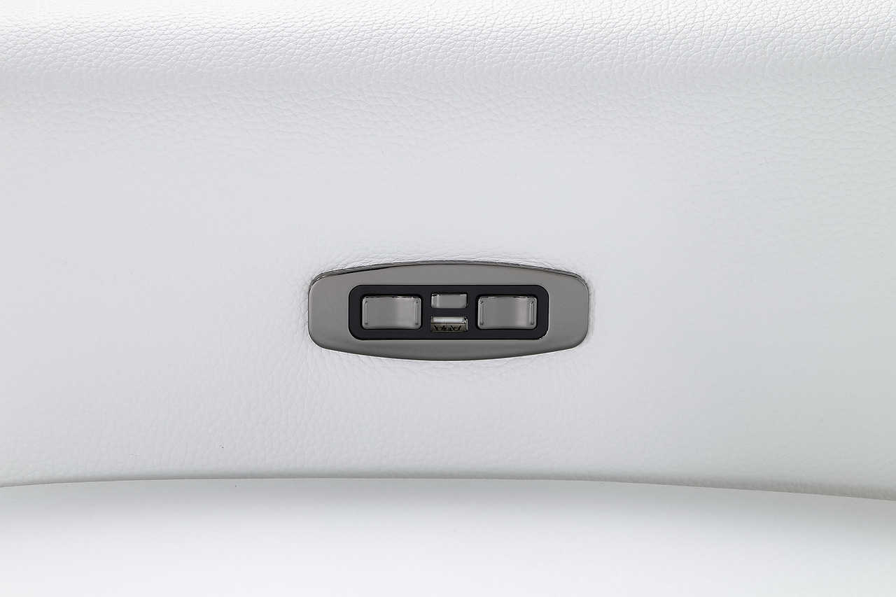 Close-up on power recliner control on white leather sectional