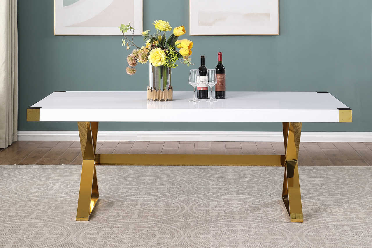 Close-up of white lacquer wood top and gold stainless steel leg detail