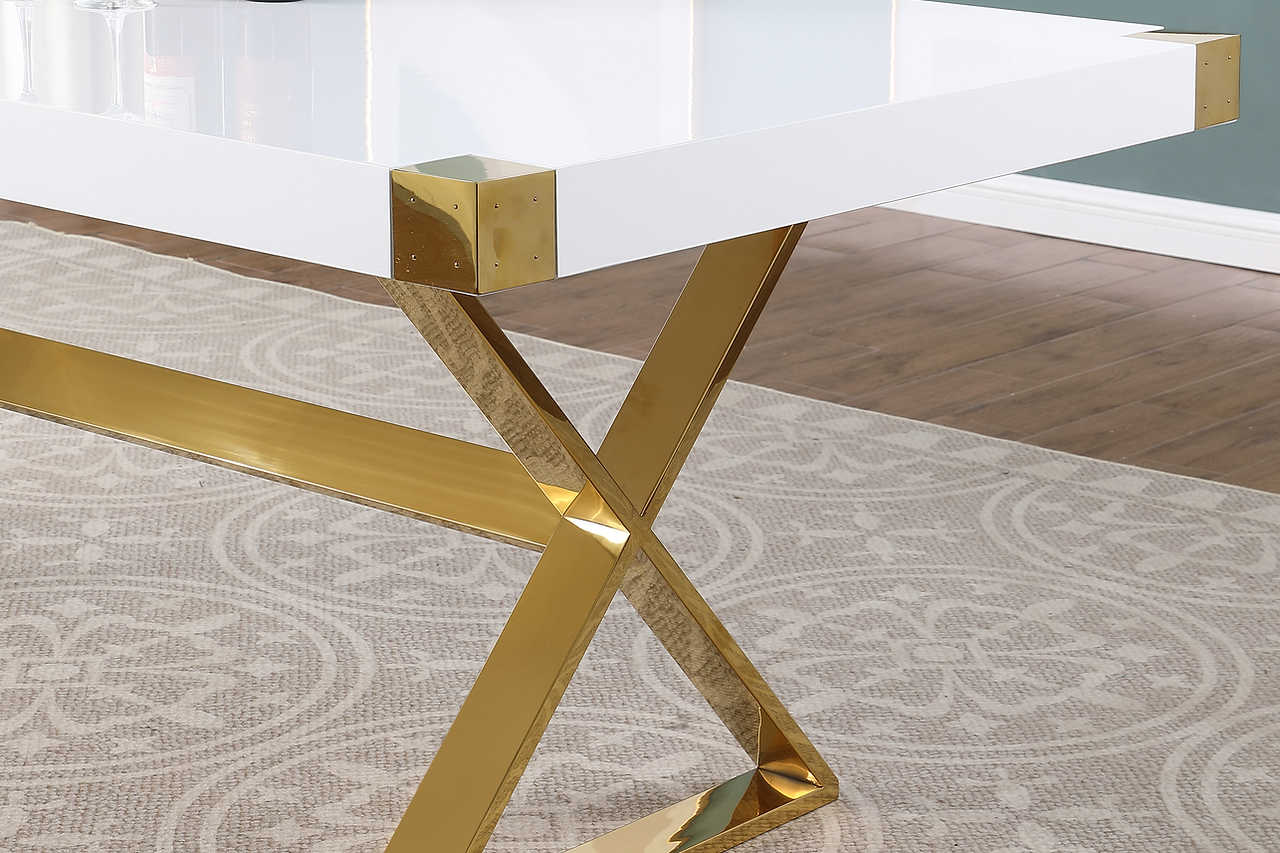 Adel dining table showing gold corner pads on white lacquer top