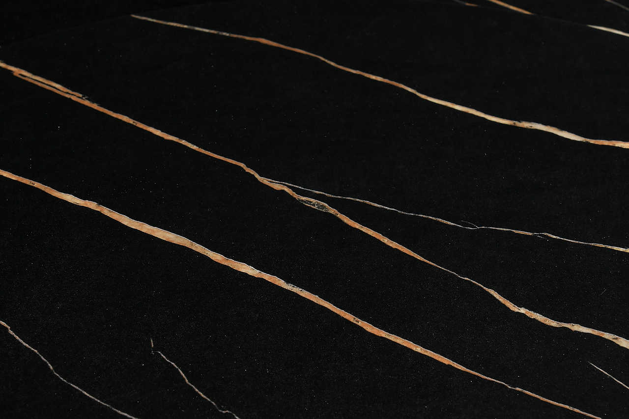 Unico dining table black and gold marble-effect top side view