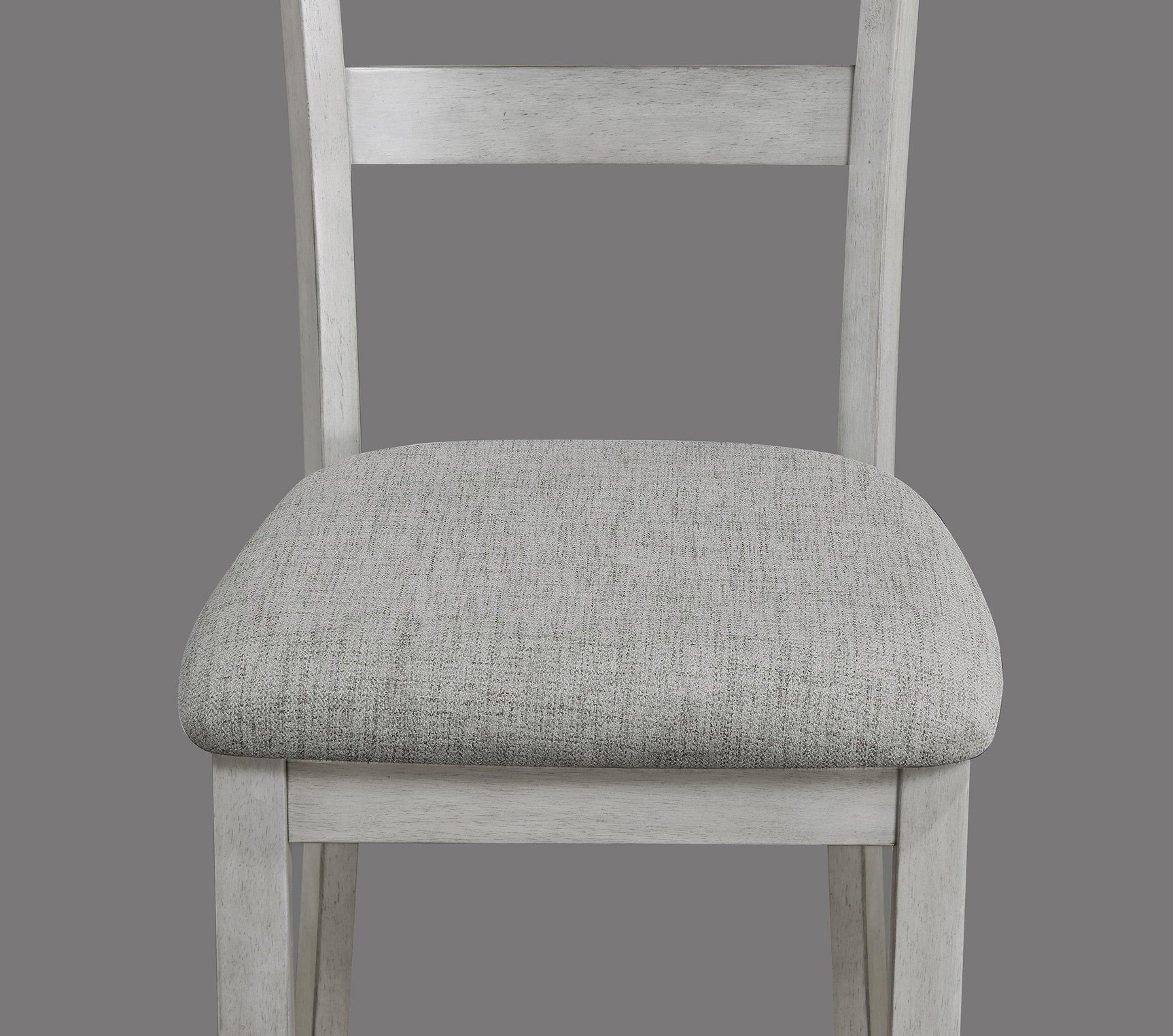 Side view of Henderson driftwood dining table with four upholstered chairs