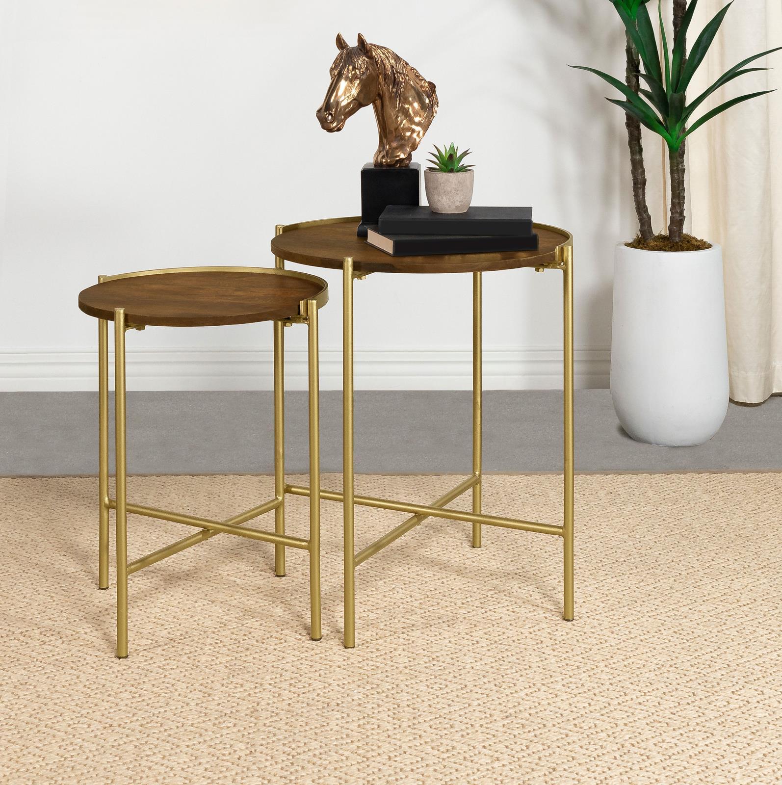 Close-up of Malka round nesting table gold iron base with X-brace