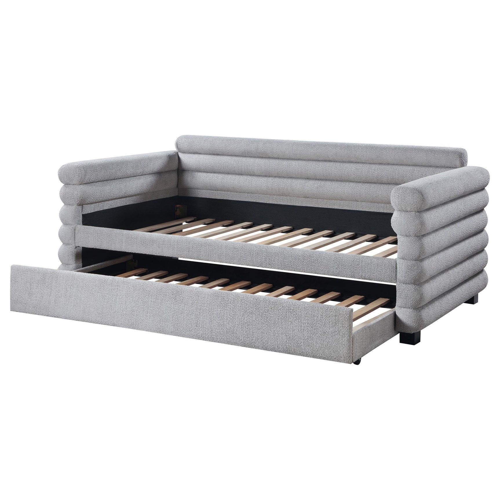 Grey upholstered twin daybed with trundle against white background
