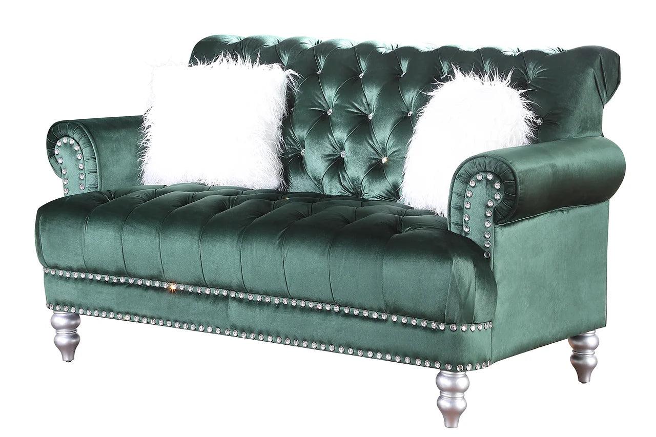 Close-up of green velvet tufted upholstery on sofa and loveseat
