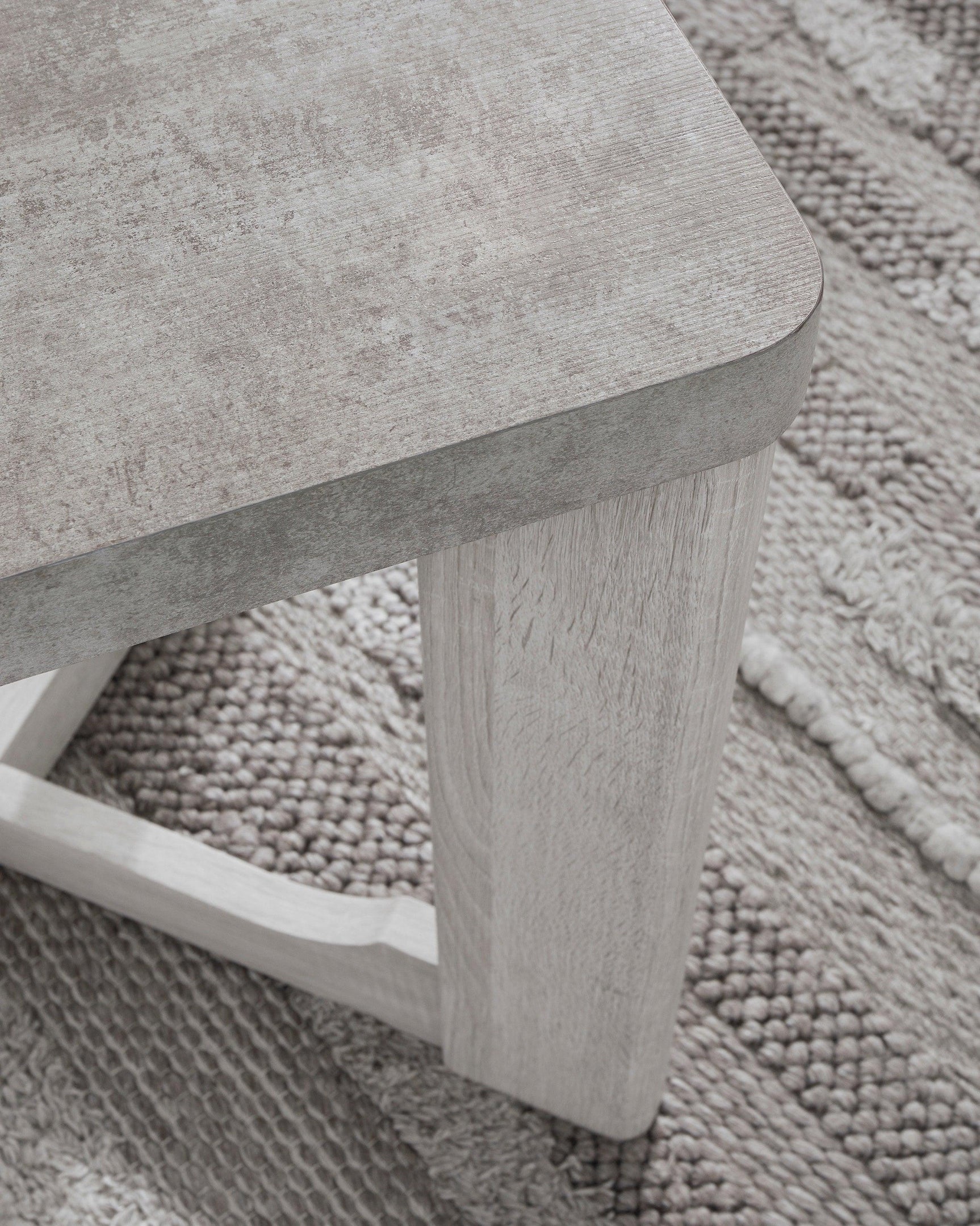 Side view of Garnilly whitewash end table with visible leg design