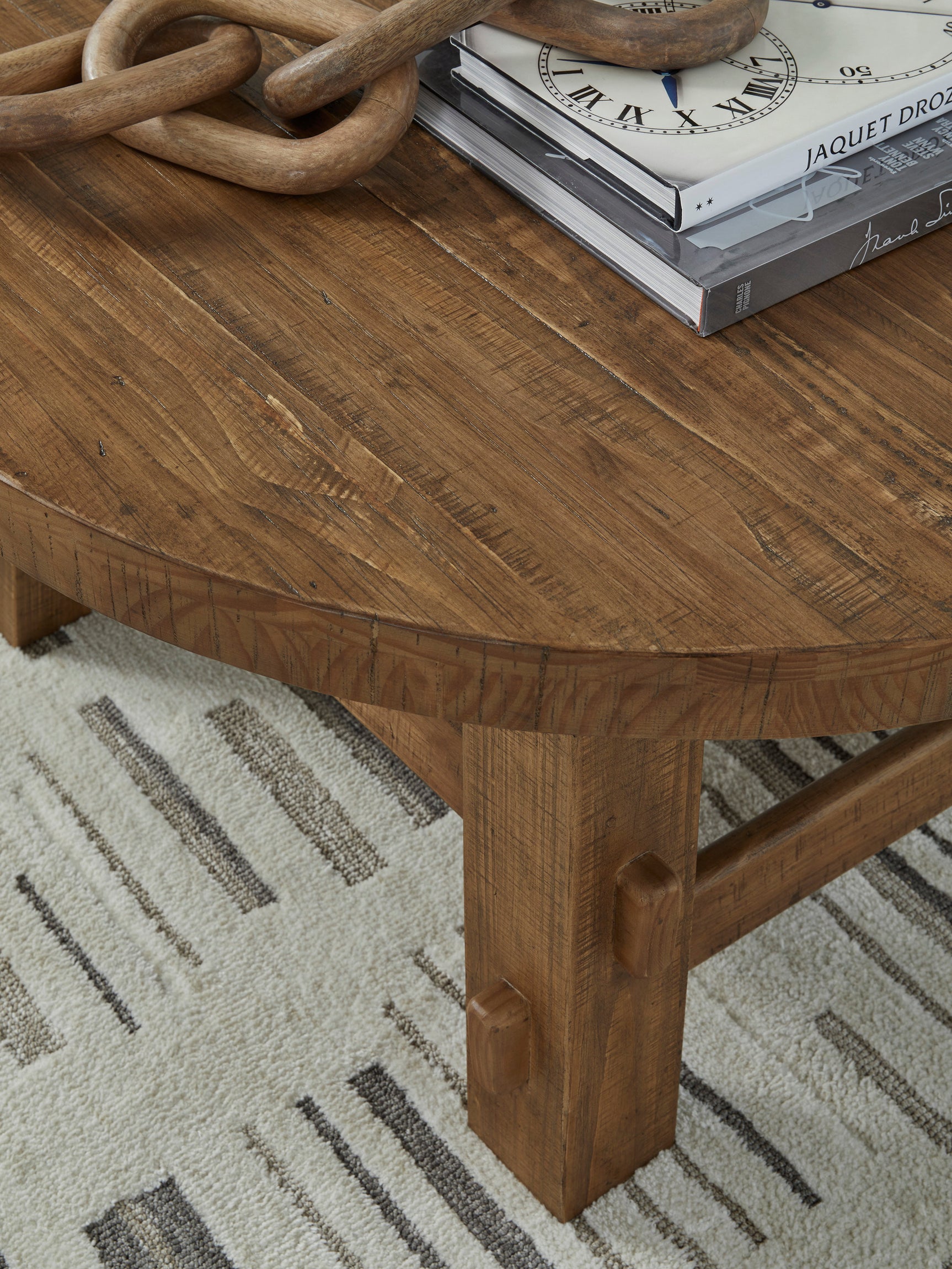 Side view of Mackifeld Cocktail Table in warm brown finish