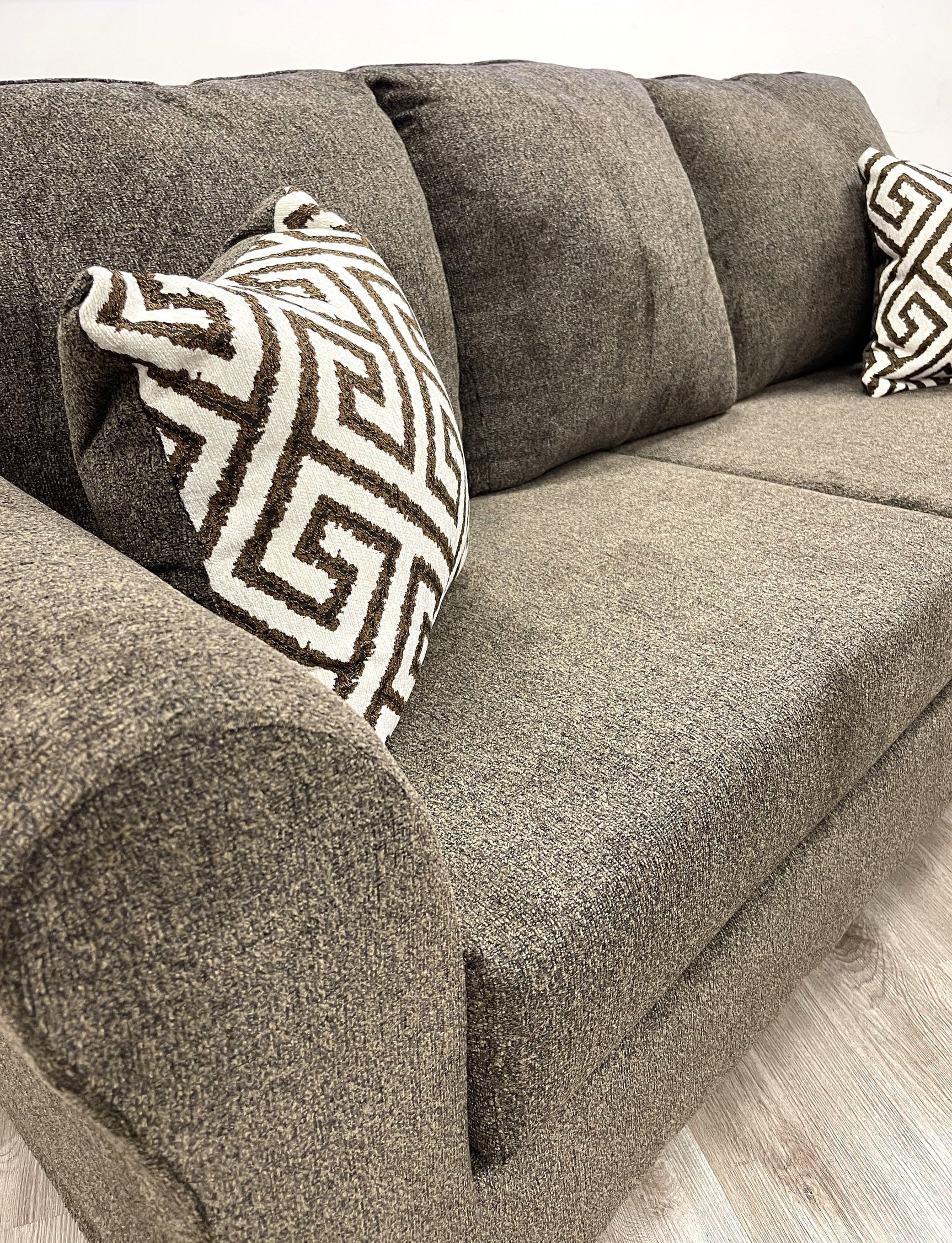Close-up detail of chenille-like fabric on Tuten Brown Living Room Set