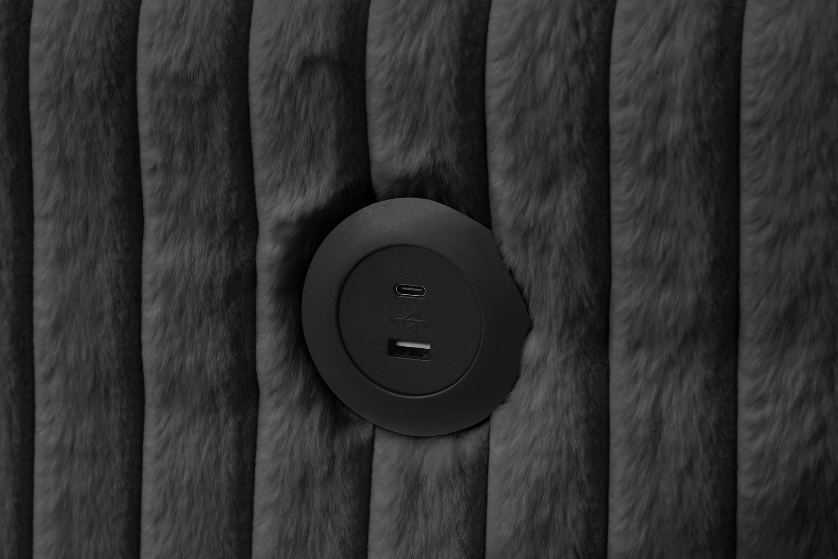 Close-up detail of black upholstery and storage chaise on July sectional sofa