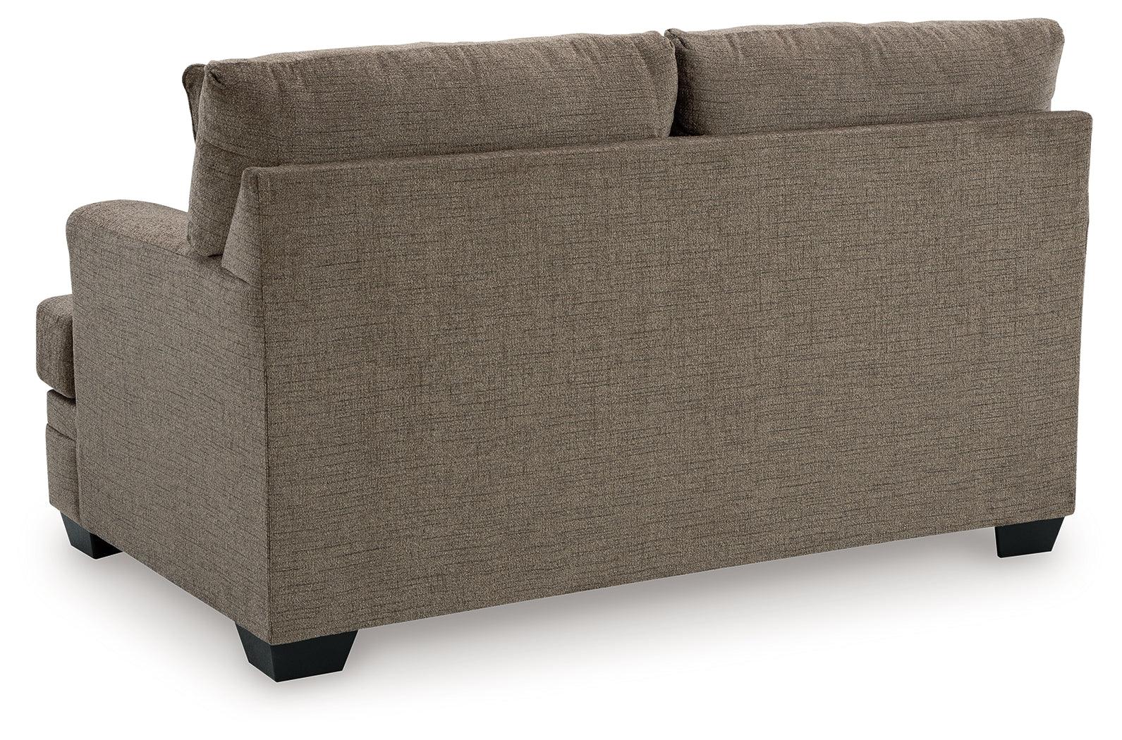 Exposed faux wood finish feet on loveseat
