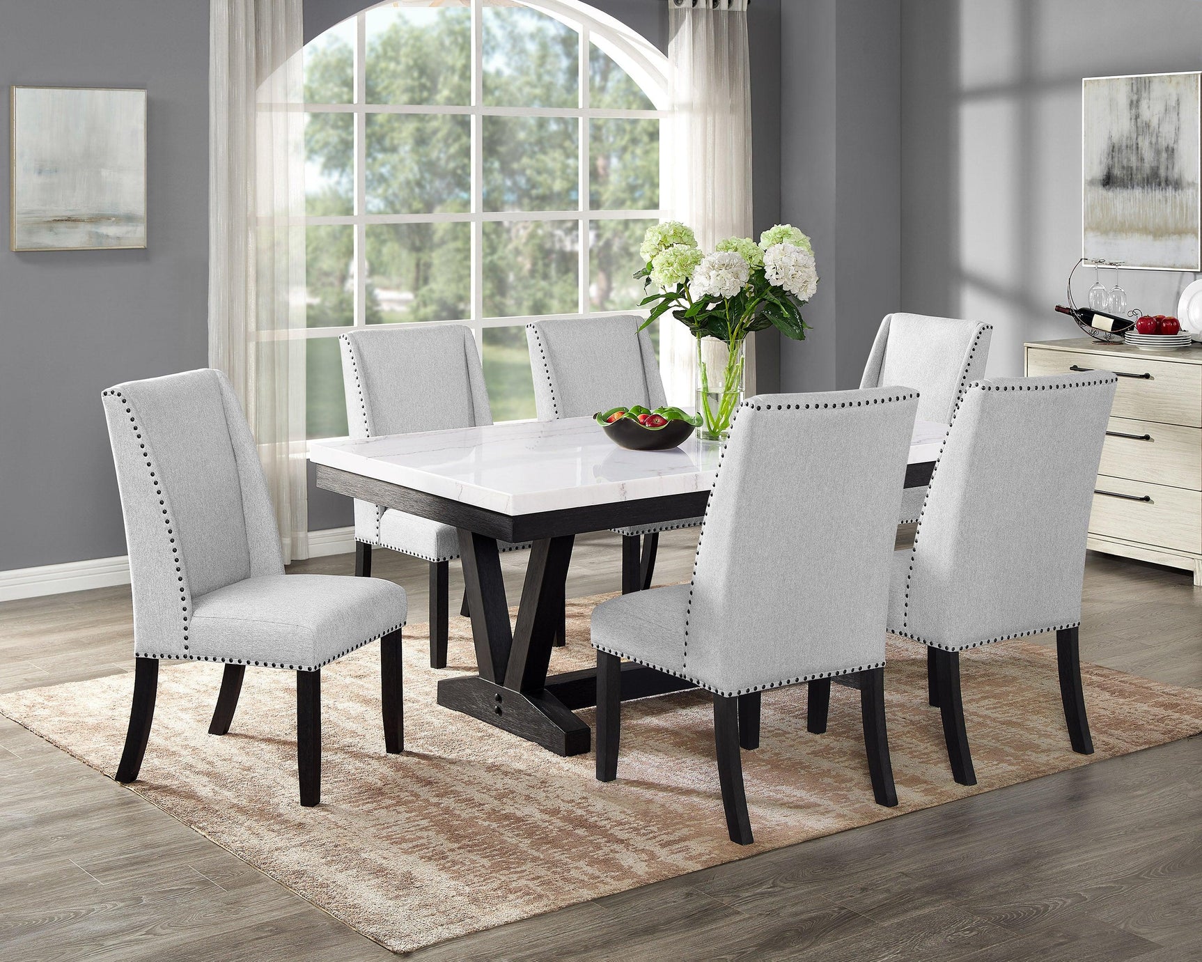 Room view of Varley Vance dining set with white marble top and fabric chairs