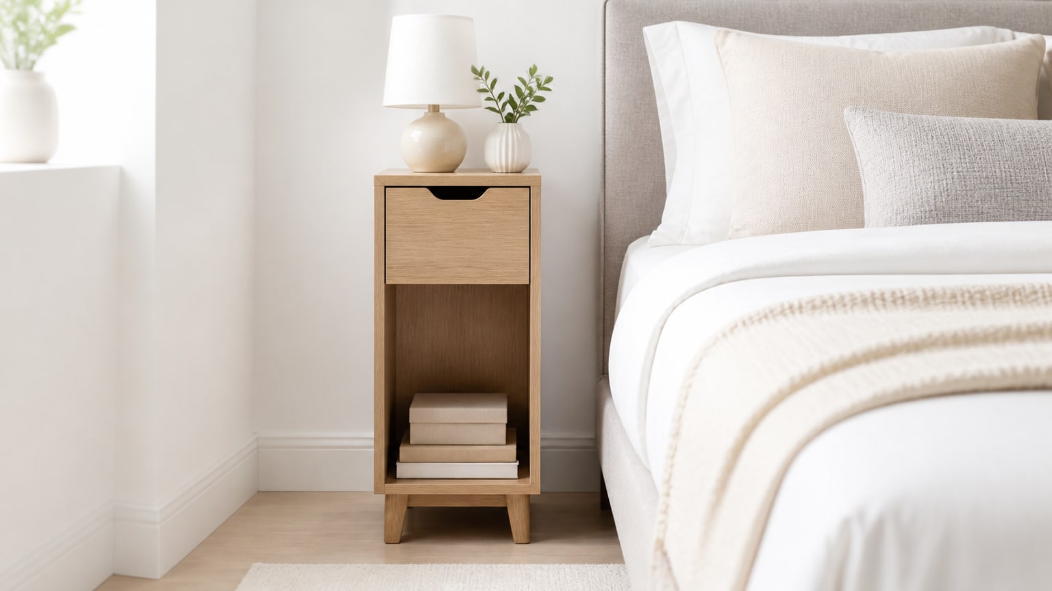 Modern narrow nightstand with drawer and open shelf on white background