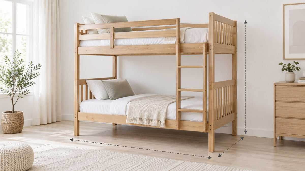 Light wood twin-over-full bunk bed with stairs and storage drawers in a bright neutral bedroom