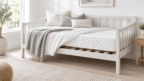 Bright white bedroom featuring a stylish daybed with twin mattress and pull-out trundle in a neutral setting