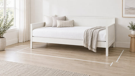 Contemporary daybed with partially extended trundle in a neutral, bright bedroom setting featuring wood and upholstery with clean lines and spacious layout.