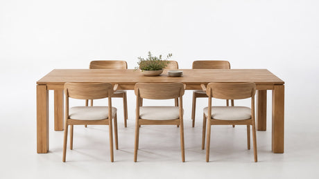 Rectangular wooden dining table with six chairs on a clean white background