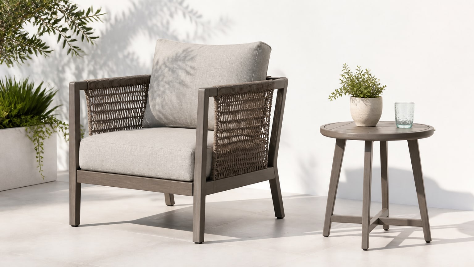Modern outdoor sectional sofa and dining table set on a bright white patio background