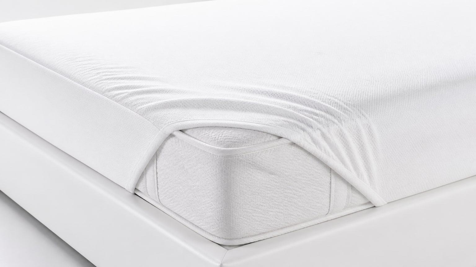 Close-up view of a modern mattress on a bed frame with white background showcasing clean fabric and smooth surface
