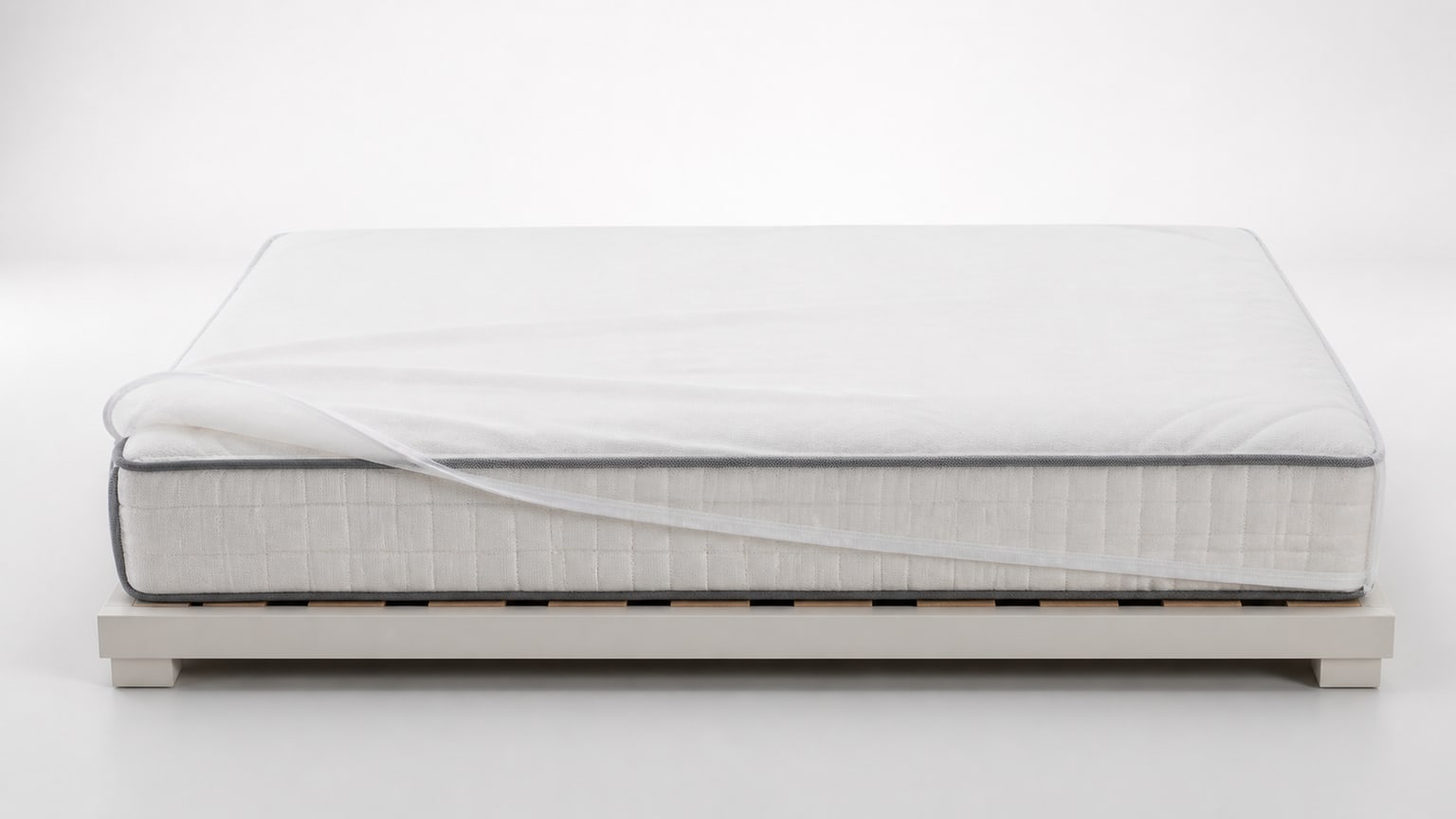 A modern mattress viewed from the side on a white background, illustrating mattress care and storage