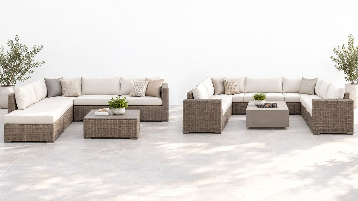 Modern U-shaped outdoor sectional with cushions, coffee table, and umbrella on bright white patio background