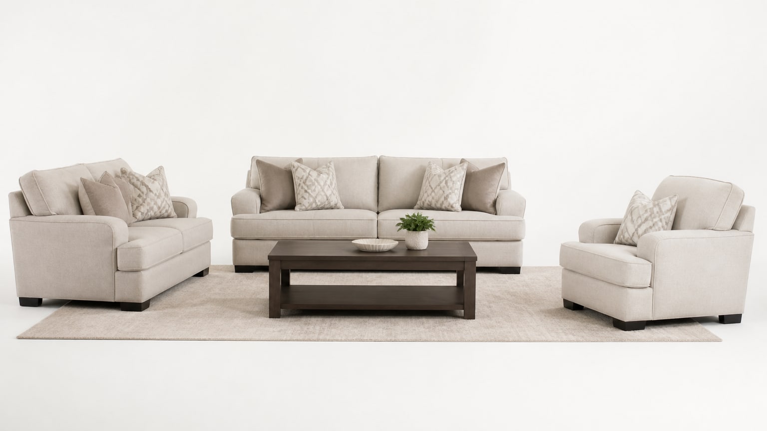 Coordinated living room furniture set including sofa, loveseat, chair, coffee table, and rug on white background