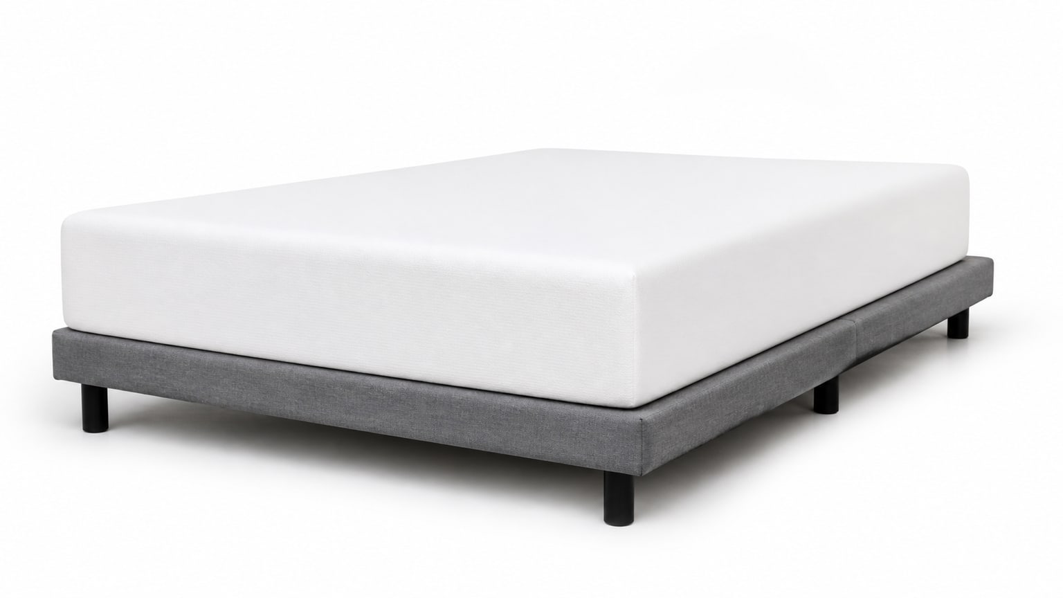 Memory foam mattress on a box spring mattress foundation with clean white background.