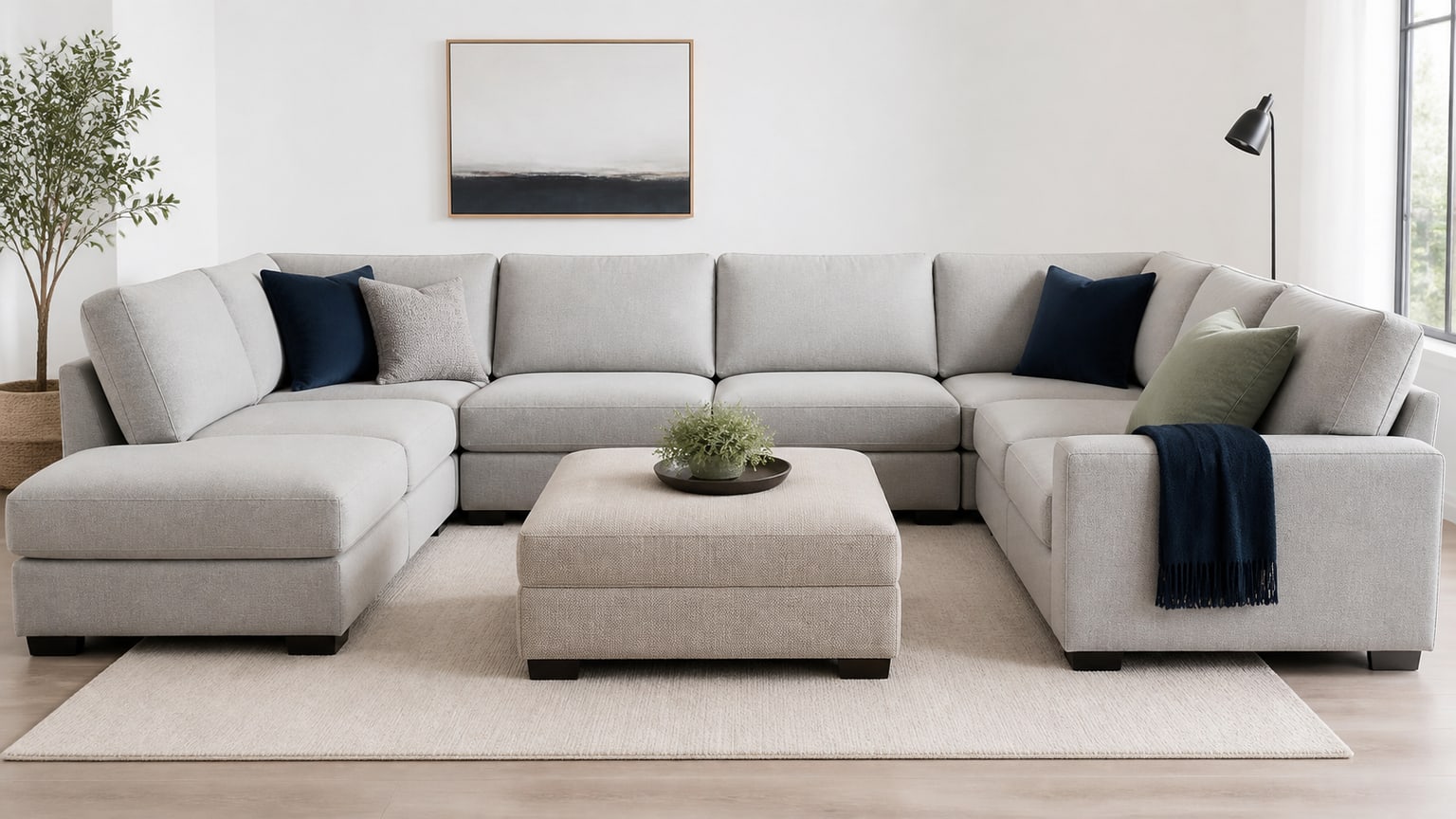 Contemporary sectional sofa with upholstered ottoman on clean white background, studio photography