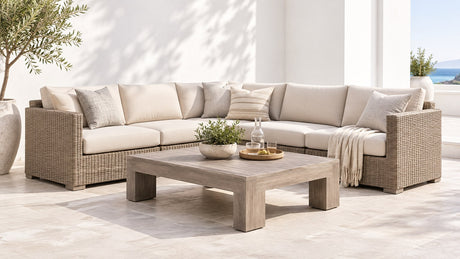 Professional outdoor sectional furniture with coffee table on bright white patio background