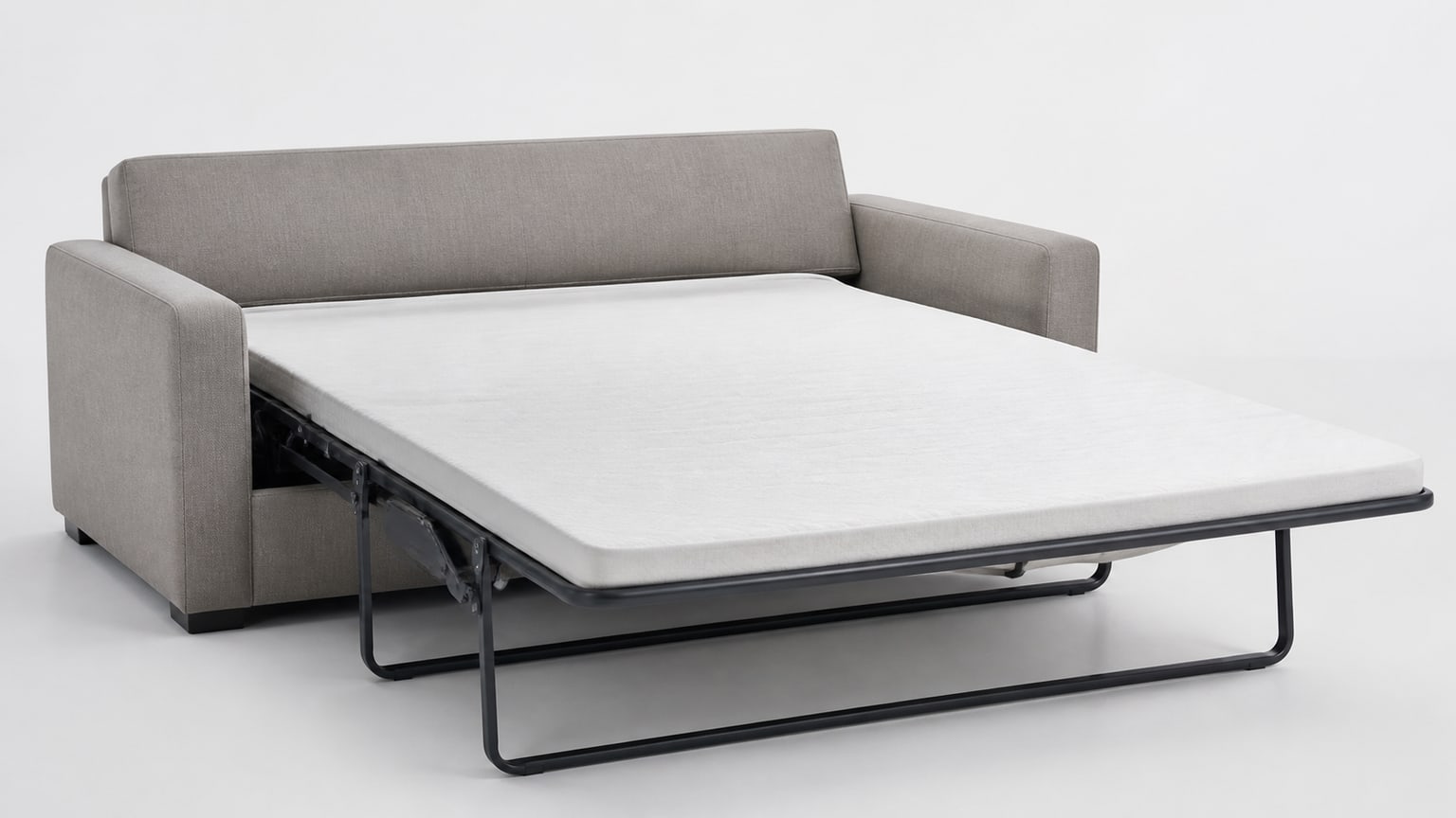 Modern sleeper sofa bed with mattress partially pulled out on a white background