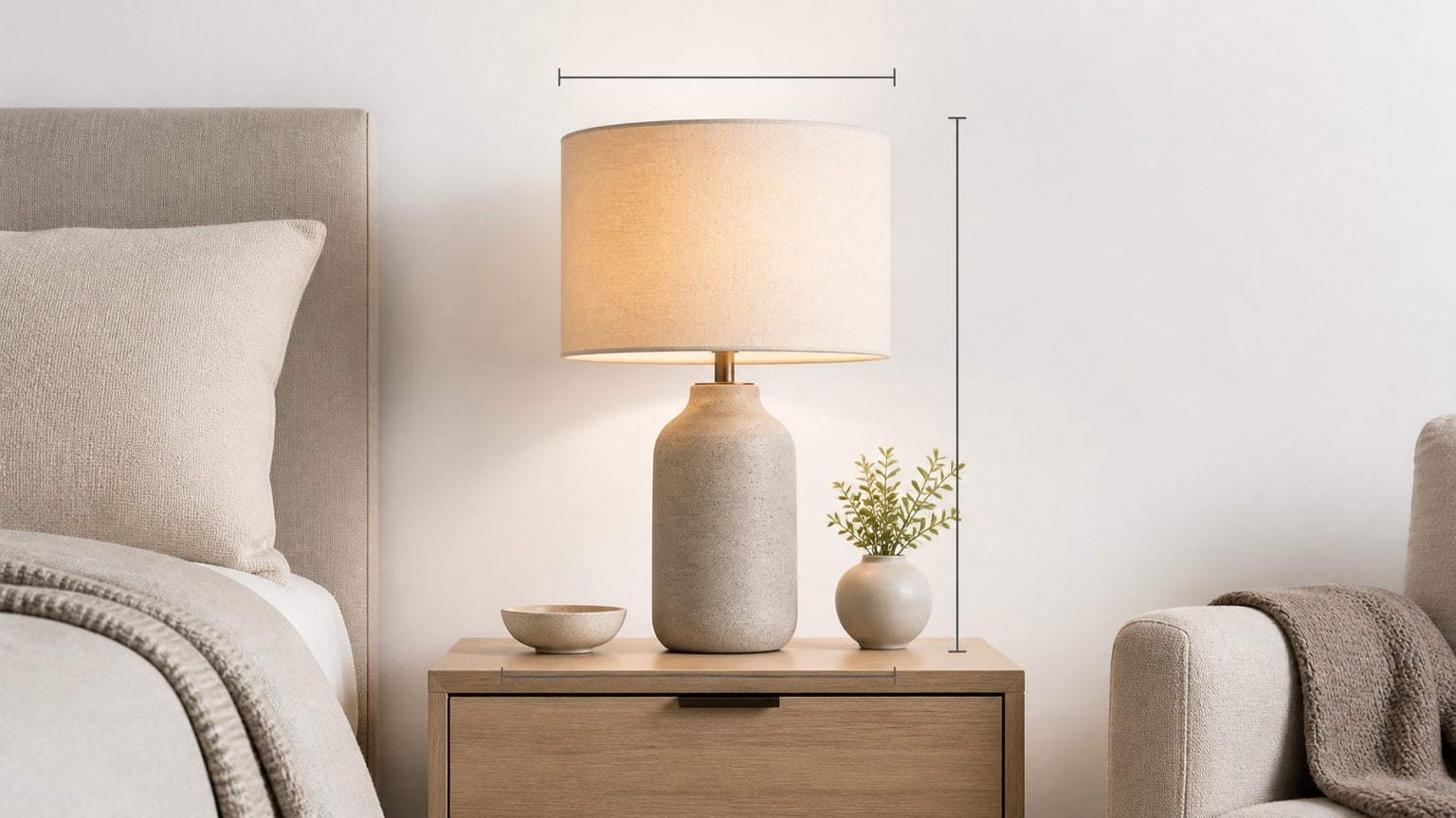Stylish table lamp with drum shade and metal base on a wooden end table with warm soft light