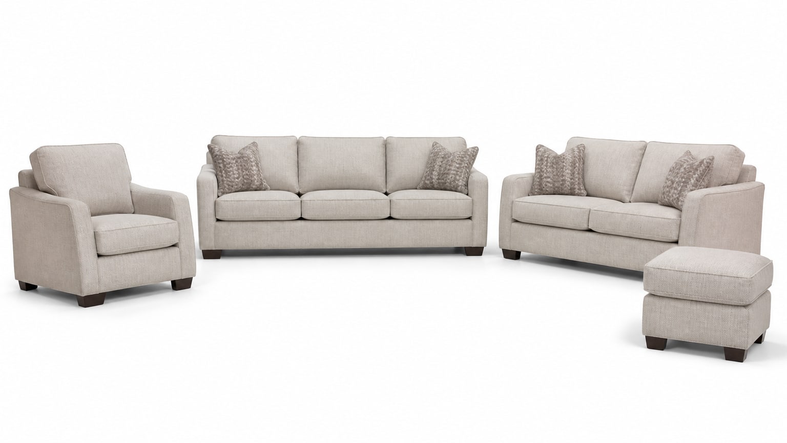 Coordinated living room furniture set with sofa, loveseat, chair, coffee table, and area rug on white background
