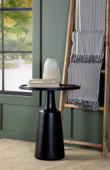 Ixia Round Mango Wood Accent Table with black tabletop and contoured base, angled view