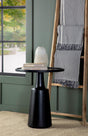 Ixia Round Mango Wood Accent Table with black tabletop and contoured base, angled view