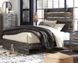 Front view of Drystan Multi Queen Panel Bed showing rustic finish and headboard