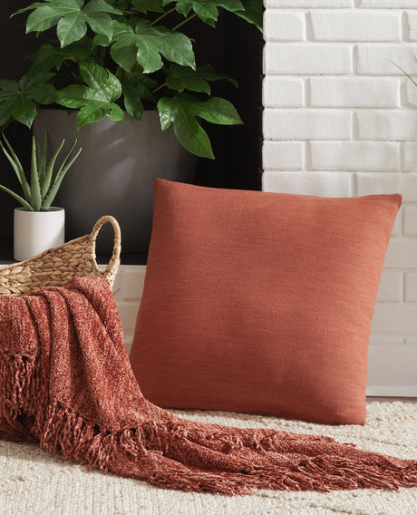 Thaneville rust accent pillow showing front angle